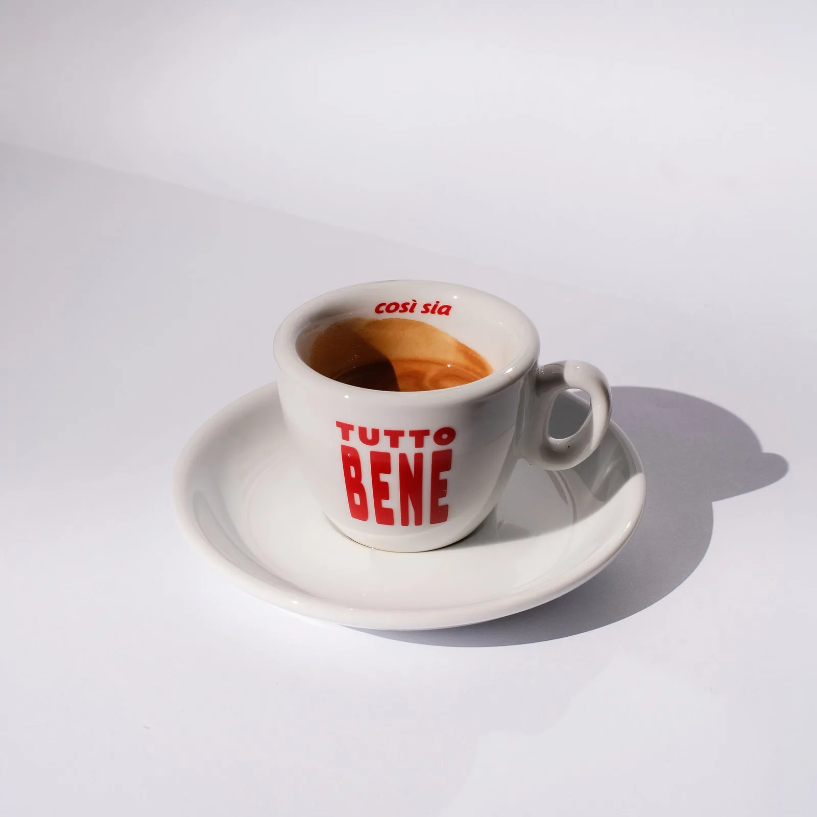 Tutto Bene designer espresso cup by artless STUDIO — bold red typography on white porcelain